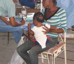 Mother with Child in Clinic Post-Earthquake Haiti